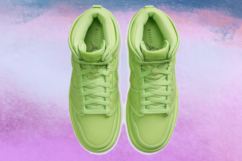 billie-eilish-tenis-nike-04 Foto do tênis verde neon no modelo Air Jordan 1 KO da coleção da Billie Eilish com a Nike em fundo lilás, roxo e azul